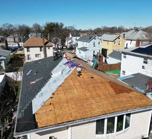Roof insurance claim Long Island - aerial view of storm-damaged residential roof