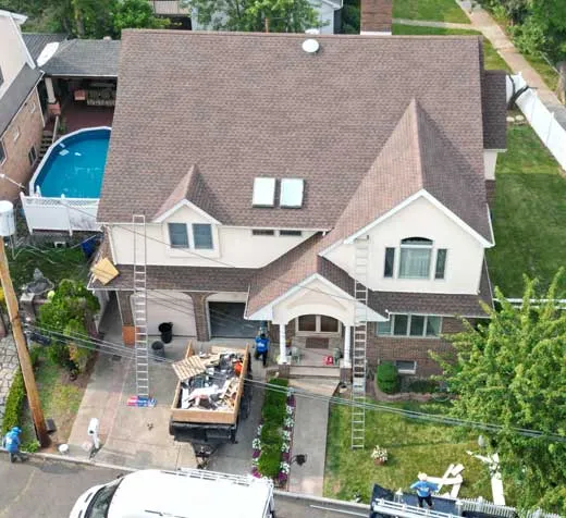 Roof insurance claim Long Island - aerial view of storm-damaged residential roof